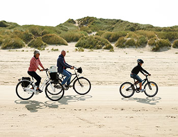 Familie cykler på Blokhus Strand